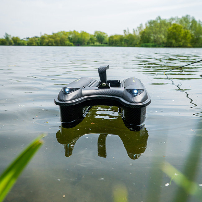A bait boat on the water ready for a carp fishing session