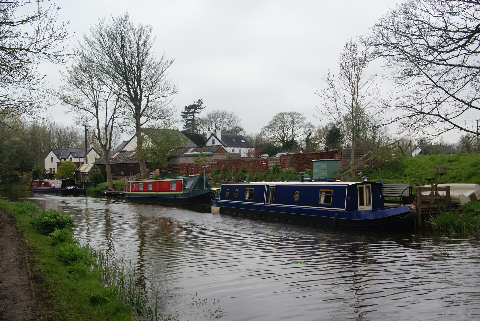 Narrowboats moored on the Lancaster Canal under bare winter trees