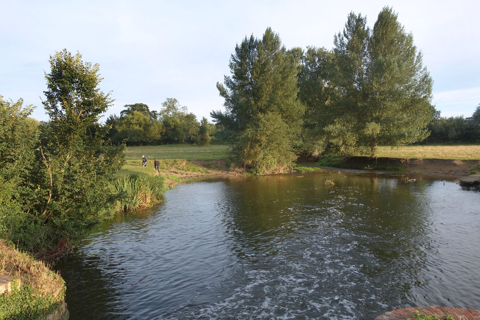 A weir pool on the River Stour with slower water below the weir