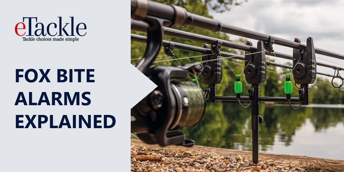 Fox bite alarms with green swingers on rods beside a lake